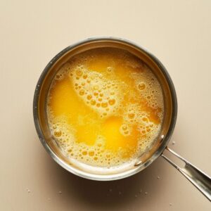Small saucepan with chicken broth gently simmering for pastina recipe