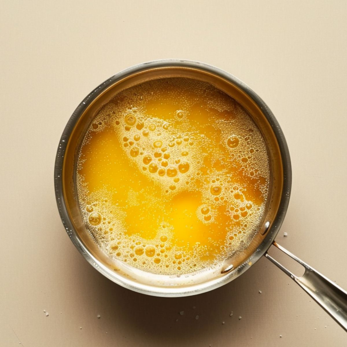 Small saucepan with chicken broth gently simmering for pastina recipe