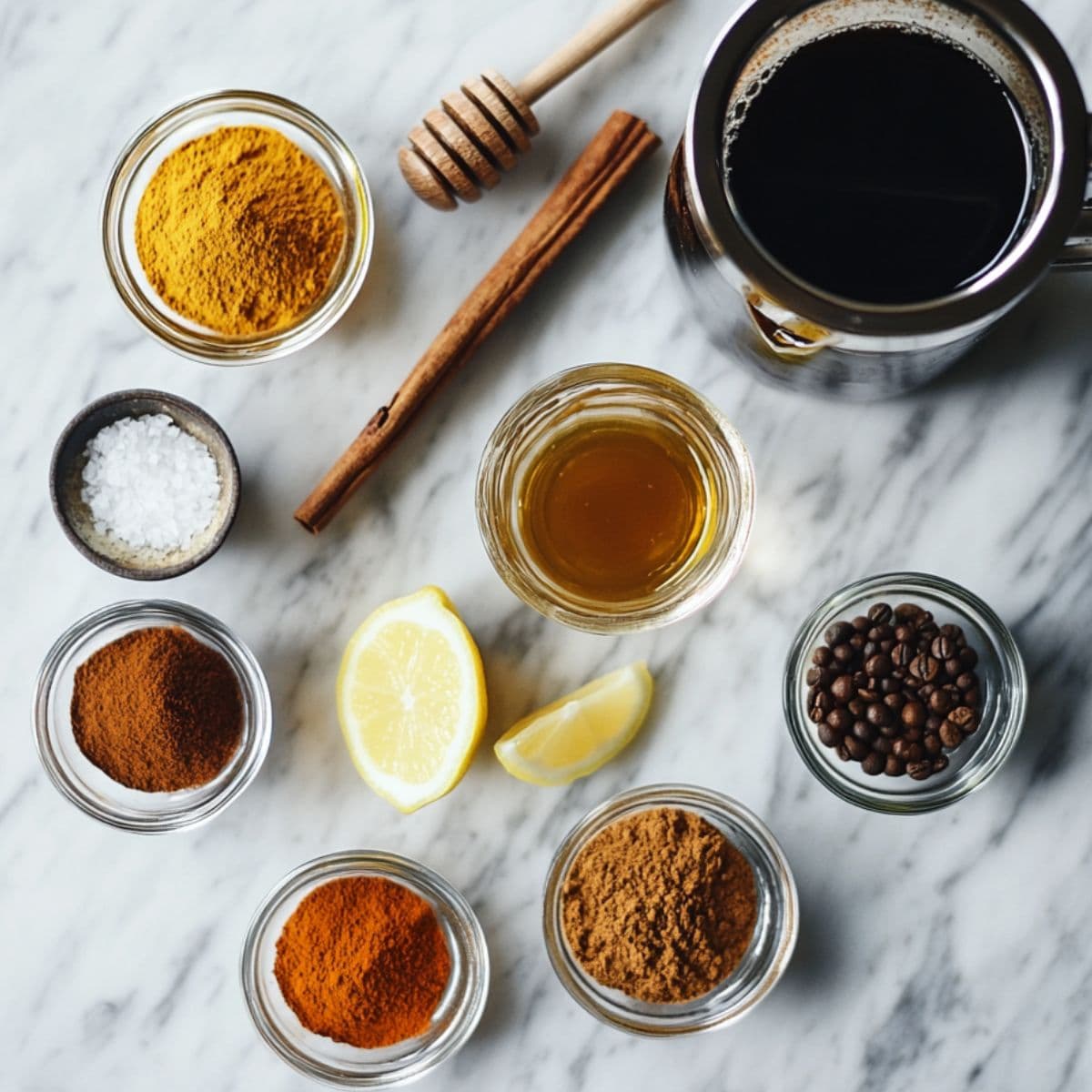 Small bowls of cinnamon, turmeric, black pepper, and coconut oil next to a cup of black coffee , Easy Coffee Loophole Recipe ingredients