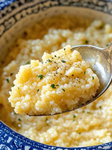 Creamy pastina recipe served in a white bowl with spoon, captured in soft daylight