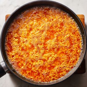 add liquid and simmer spanish rice recipe with broth until rice is tender and infused with flavor