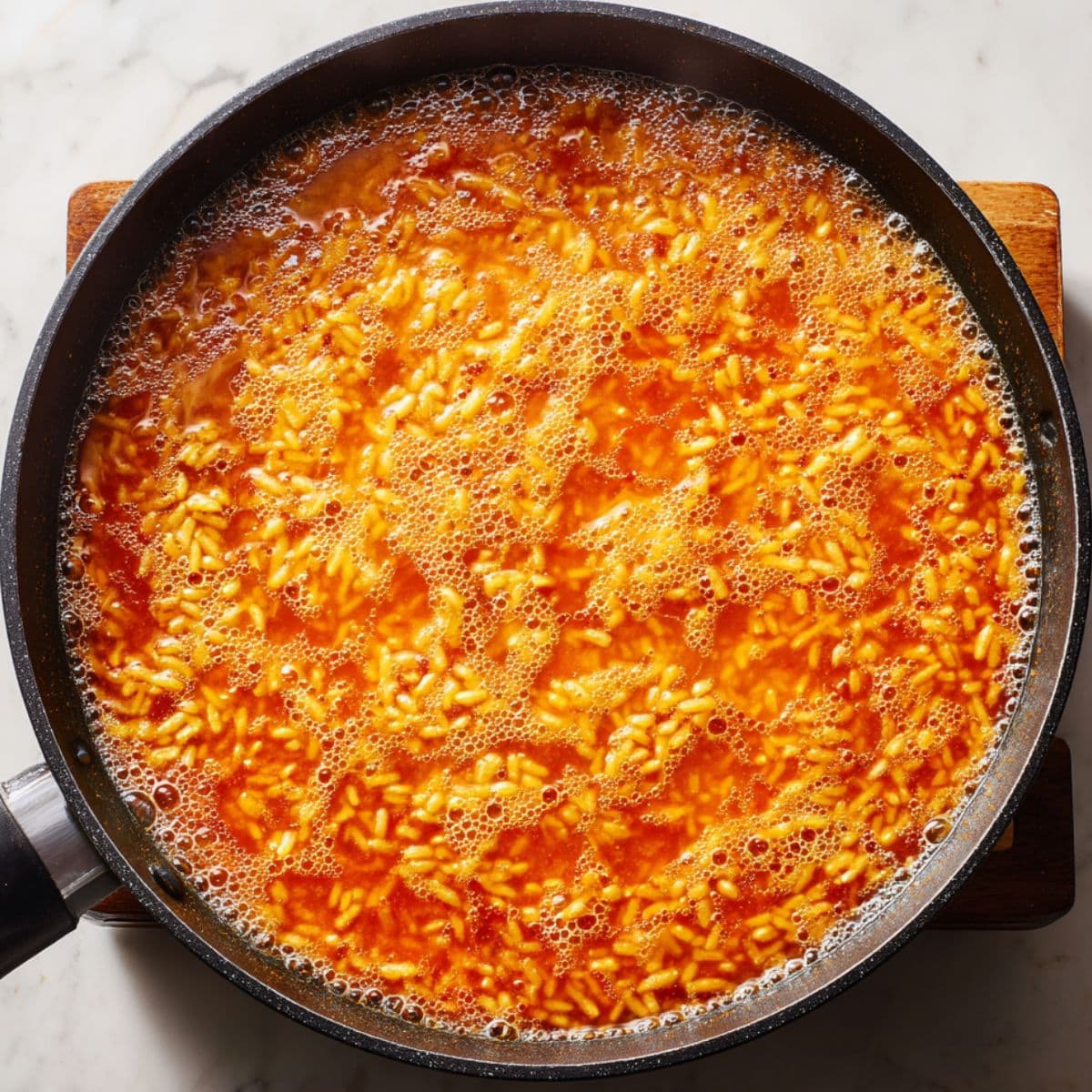 add liquid and simmer spanish rice recipe with broth until rice is tender and infused with flavor