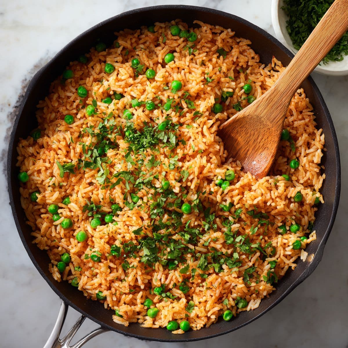 fluff and finish spanish rice recipe with peas and cilantro for light, fluffy texture