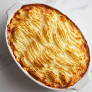 layer and bake cottage pie recipe with mashed potatoes spread over meat filling and baked golden