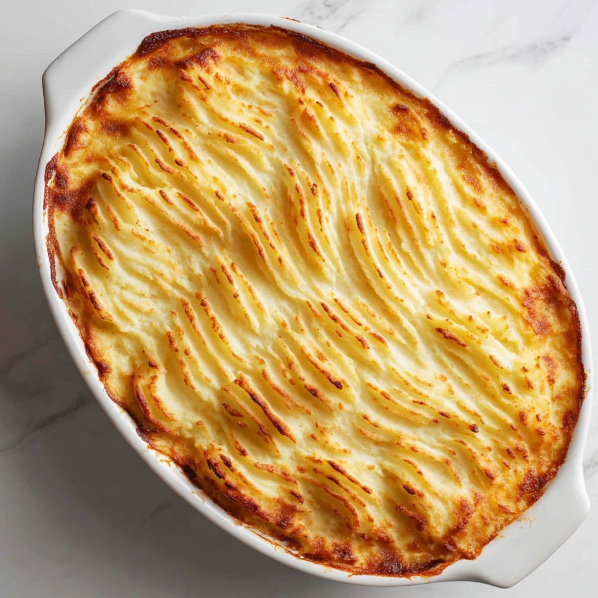 layer and bake cottage pie recipe with mashed potatoes spread over meat filling and baked golden