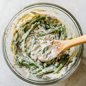 mix the base of green bean casserole recipe with soup, green beans, milk, and pepper