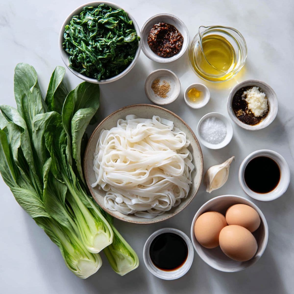 phat si-io recipe essential ingredients including wide rice noodles, soy sauces, and gai lan