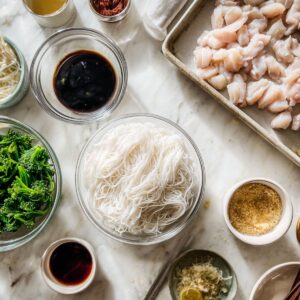 prep everything first for phat si-io recipe with soaked noodles, chopped broccoli, and mixed sauce