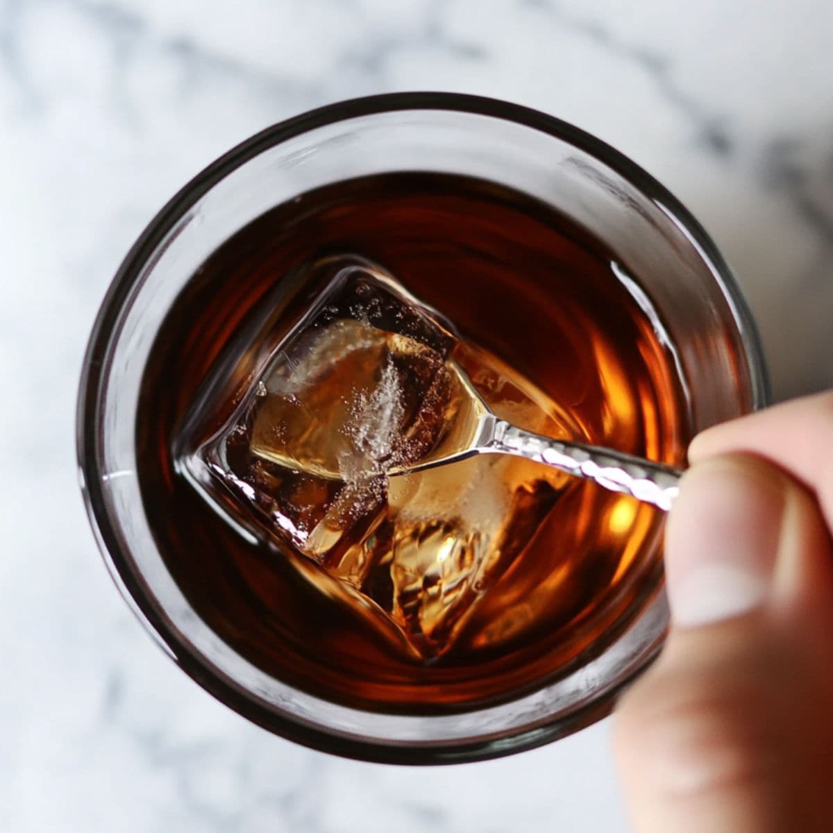 stirring black manhattan recipe over ice