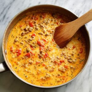 add the good stuff for rotel dip recipe with Rotel tomatoes stirred into cheese and beef