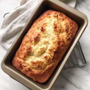 avocado bread loaf baking in oven in greased pan