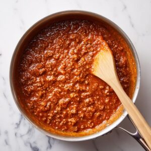 melt the magic for rotel dip recipe with cubed Velveeta melting into beef mixture