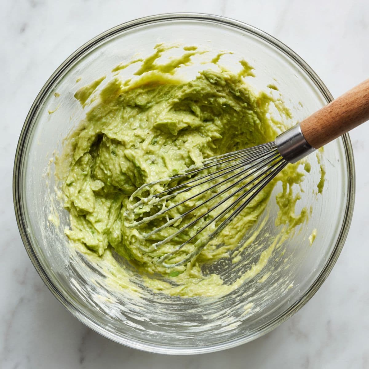 mashed avocados mixed with eggs, vanilla, and sweetener for avocado bread recipe