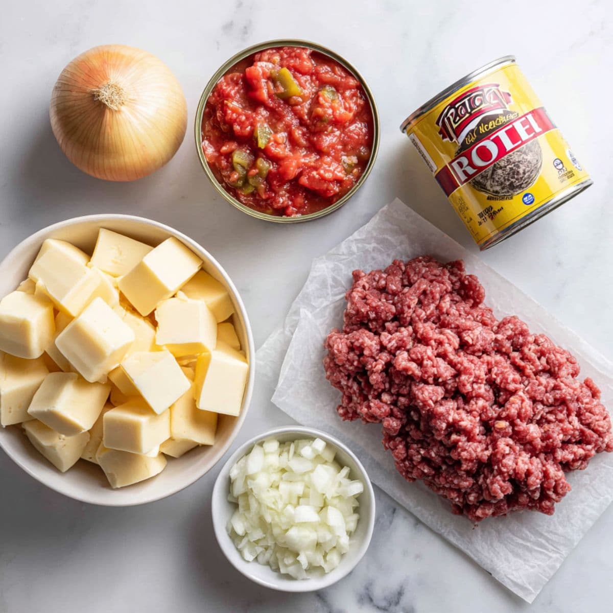 rotel dip recipe essential ingredients including Velveeta, ground beef, Rotel, onion, and garlic