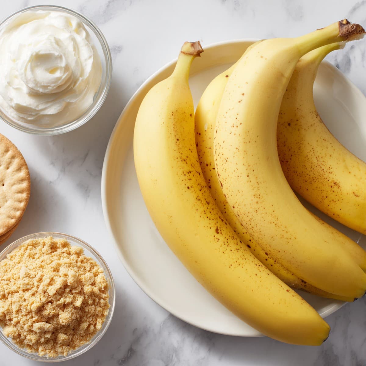 banana pudding recipe layering ingredients including bananas, wafers, whipped cream, and crushed wafers