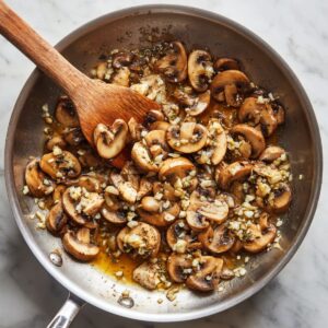 mushrooms, garlic, and shallots cooking in skillet for chicken marsala