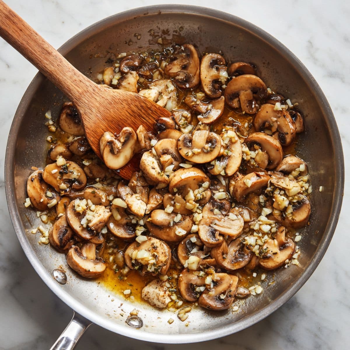 mushrooms, garlic, and shallots cooking in skillet for chicken marsala