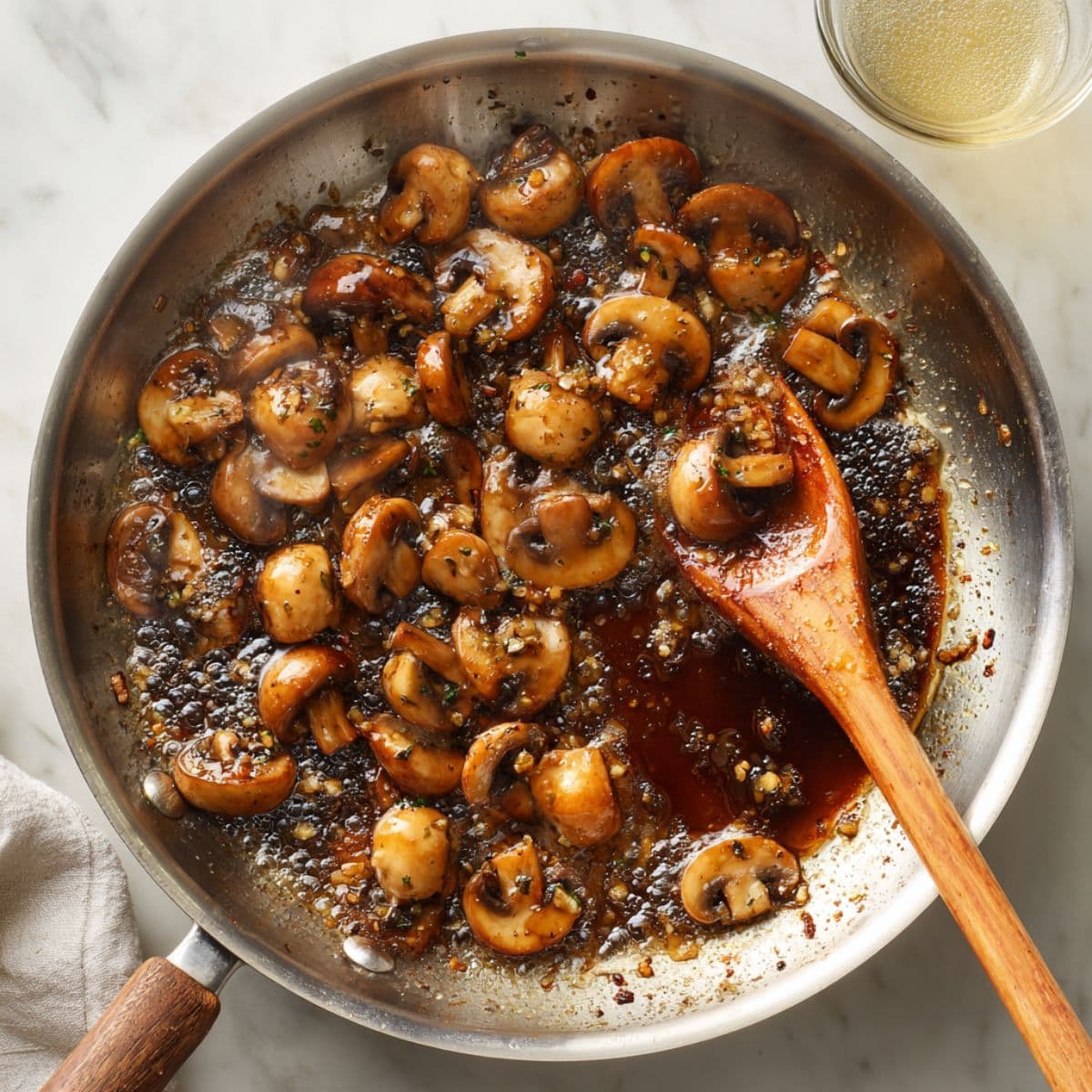 marsala wine simmering with mushrooms in skillet