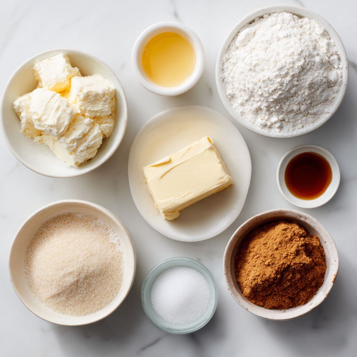 butter, cream cheese, sugar, egg, vanilla extract, all-purpose flour, baking powder, and salt arranged neatly on white marble