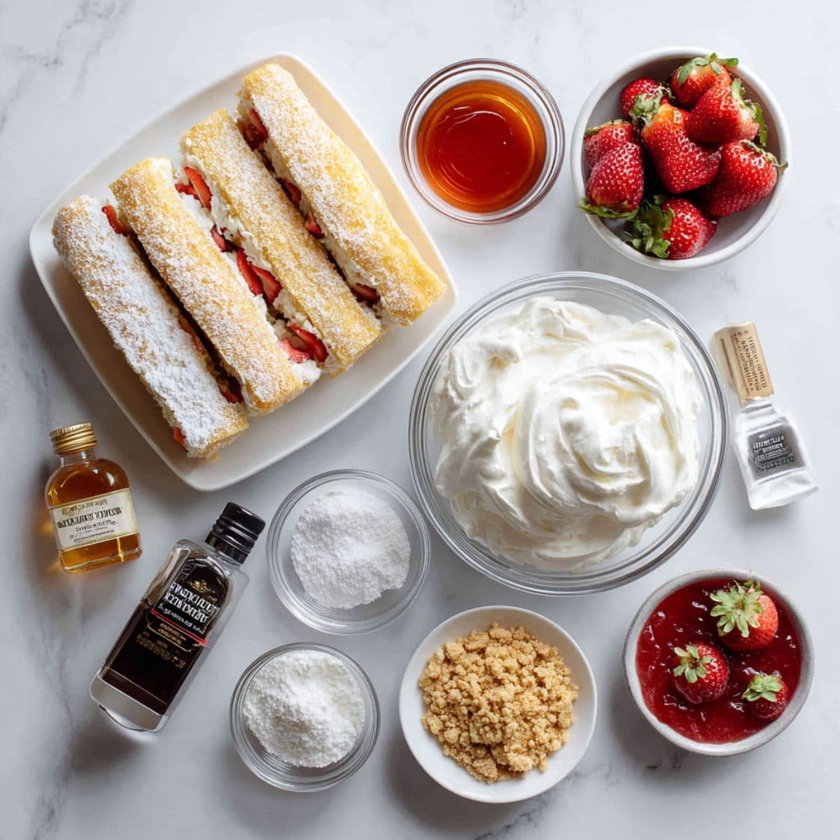 pound cake, whipped cream, strawberries, jam, and golden oreos arranged on white marble