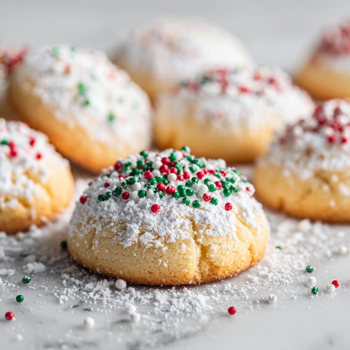 coating italian christmas cookies in powdered sugar