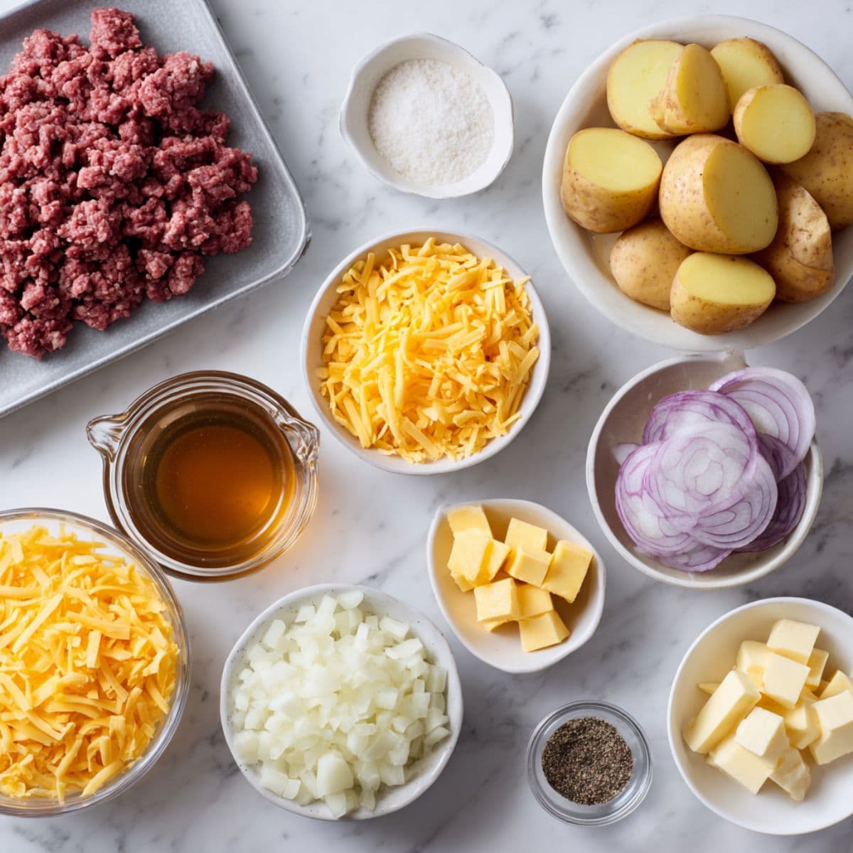 hobo casserole ingredients on white marble