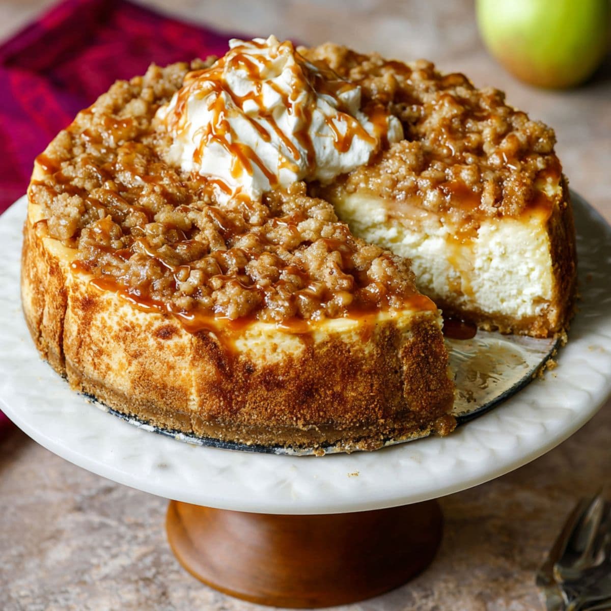assembling apple pie cheesecake with apple topping