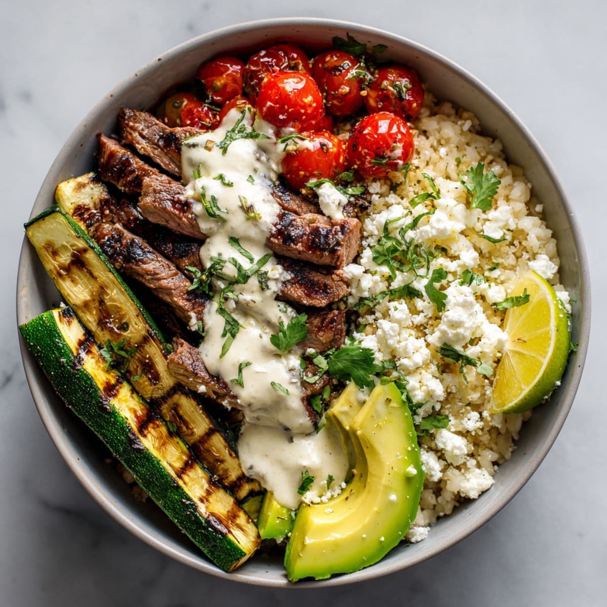assembling grilled steak bowl with creamy sauce and zucchini