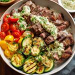 grilled steak bowl with creamy sauce and zucchini